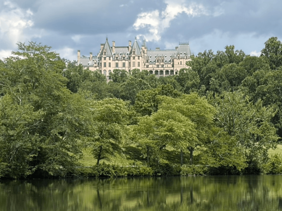 Biltmore House viewed across a lagoon at Biltmore Estate, Asheville NC, with reflection in the water Biltmore House viewed across a lagoon at Biltmore Estate, Asheville NC, with reflection in the water