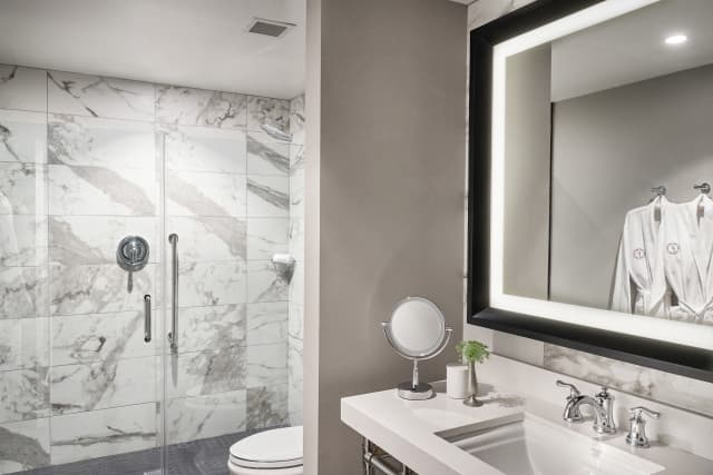 Waterfall shower heads, complimentary robes, marble accents Waterfall shower heads, complimentary robes, marble accents